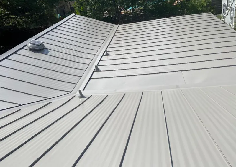 Solar attic fan installed on a metal roof for Roof Ventilation in Lincolnwood